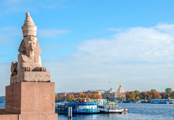 Egyptian Sphinx statue on the University Embankment and view of the Neva River and sights in St....
