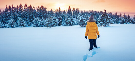Active woman in the wilderness natural park on winter sunset