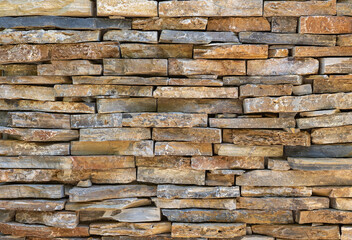 Obraz premium Texture of the facade cladding with natural stone gray sandstone.