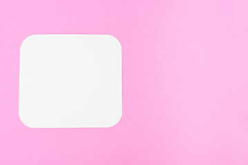 Fototapeta na wymiar blank piece of paper on a pink background, place for text. Blank card