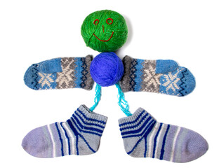 A smiling little man made of knitted things: hands - mittens, legs - socks, torso and head - balls...