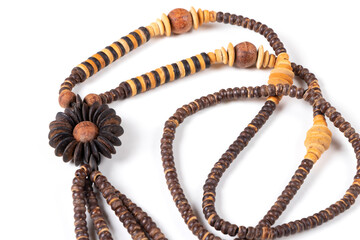 Handmade wooden souvenir beads, Thailand. Isolated on white background. Top view. Close up.