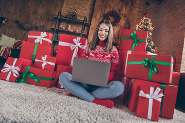 Photo of lovely lady sit boxes floor typing netbook congratulating email wear sweater in decorated x-mas home indoors