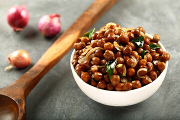 Bowl of Indian street food snack, spices fried chickpeas masala.