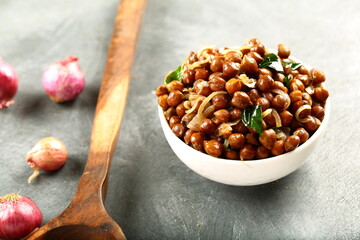 Bowl of Indian street food snack, spices fried chickpeas masala.
