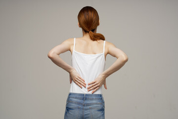 disgruntled woman pain symptoms in the joints arthritis light background