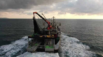 a fishing boat in the sea of turkey. Flying over a Commercial Fishing Ship that Pulls Trawl Net. Shot on Camera in 4K (UHD).