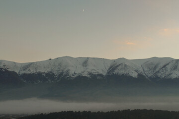 Snowy mountain landscape and new moon