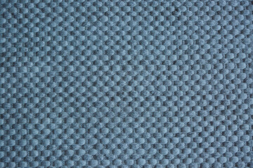 The surface texture of a natural Mat (straw, rope, or other natural material).