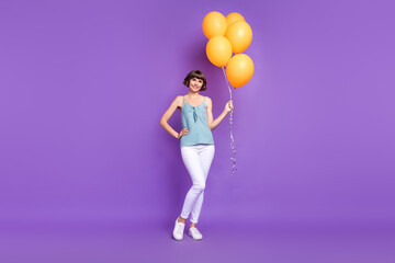 Fototapeta na wymiar Full length body size view of attractive cheerful girl holding balls isolated over bright violet purple color background