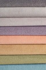 Colorful and bright fabric samples of furniture and clothing upholstery. Close-up of a palette of textile abstract stripes of different colors