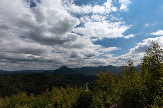 View to mountain and forest with cloudy sky