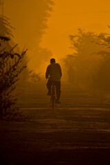 silhouette of a person on a bike