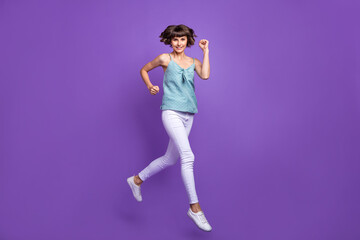 Fototapeta na wymiar Full length body size view of attractive cheerful girl jumping running isolated over bright violet purple color background