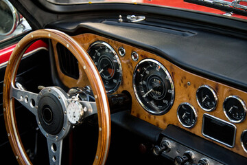 cockpit of classic car with gauges and steering wheel
