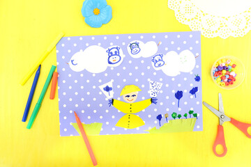 Child making card with funny cows and smiling child with glasses of milk, Creative  play with craft. The healthy food theme development of children.  School education handmade creativity.