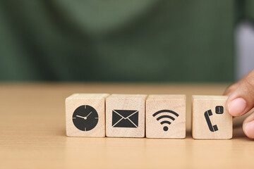 Wooden cube with icons of business communication, business process concept