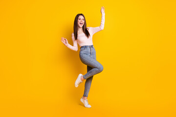 Fototapeta na wymiar Full size photo of young beautiful charming excited woman girl enjoying dancing isolated on yellow color background