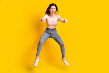 Fototapeta na wymiar Full size photo of young happy excited woman look copyspace riding invisible moped isolated on yellow color background