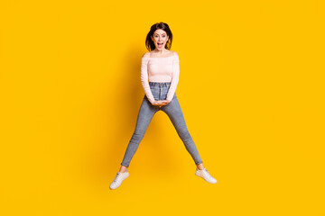 Fototapeta na wymiar Full size photo of young happy excited beautiful lovely crazy girl jumping isolated on yellow color background
