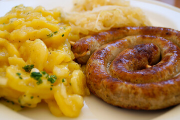 delicious bavarian fried sausage with sauerkraut a potato salad	

