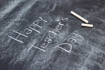 Teacher's day text with chalk on blackboard background. Happy teachers day handwriting