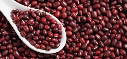 Raw adzuki red bean as background with spoon.