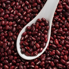 Raw adzuki red bean as background with spoon.