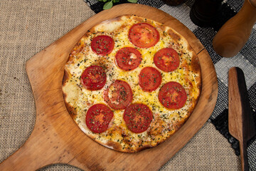 Neapolitan Brazilian pizza with mozzarella cheese and tomato slices with oregano