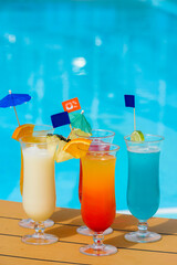 Cocktail in the sun on the edge of a swimming pool