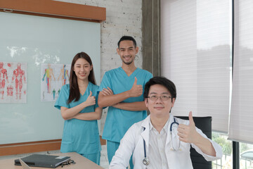 Obraz premium Healthcare trust team, portrait of three young doctors of Asian ethnicity in uniform with stethoscope, smiling and looking at camera in clinic, persons who expertise in professional treatment.