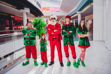 Photo of five confident animator group crossed hands enjoy winter sales wear santa elf costume in...
