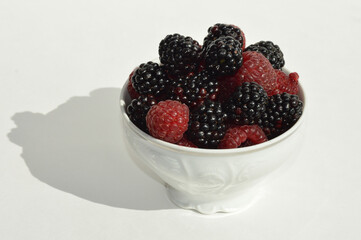 ripe, fresh berries. Raspberries and blackberries on a white background. vitamin dessert.