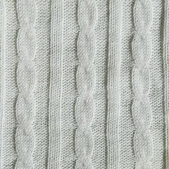 knitting with needles. a pattern of braids of thread. background for the design.