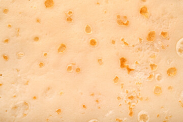 Pancake or crepe texture background. Close up of thin hot crepe image. Maslenitsa food. Top view.
