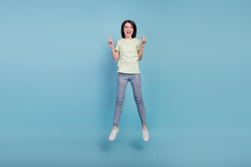 Full size photo of young excited girl good mood show peace cool v-sign isolated on turquoise color background