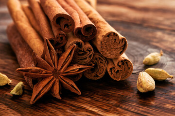 Cinnamon sticks, anise stars and cardamom on a wooden table. Set of spices for mulled wine, Christmas cake, cookies. Selective focus. close up