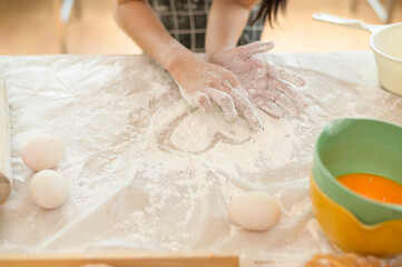 A young beautiful Asian woman is baking in her kitchen  , bakery and coffee shop business