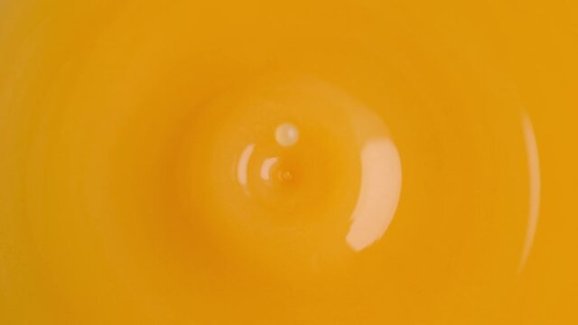Orange Juice Droplet Making Splash Crown in Slow Motion and Macro
