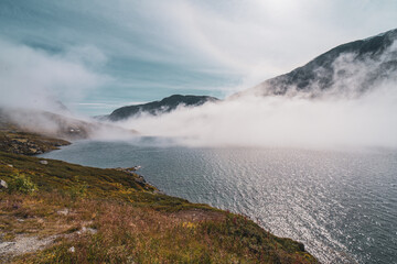Cloud in the beautiful valley landscape, lake, blue sky, rocky mountains and autumn colors