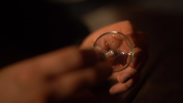 Person having light bulb in it hamds