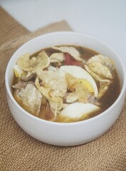 delicious chicken porridge in a white bowl with a white table