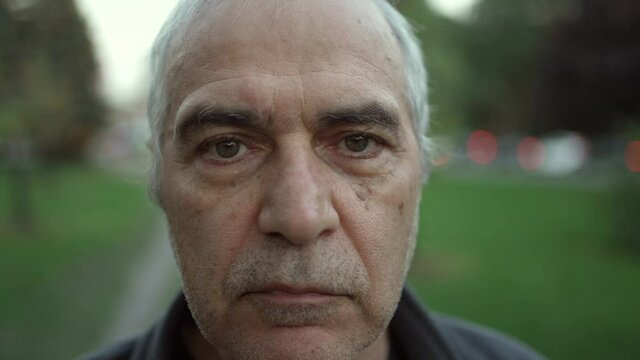 Elderly Man Serious Looking at The Camera Closeup Portrait