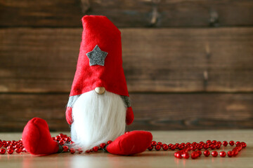 Obraz na płótnie Canvas oy Santa Claus, decorations on a wooden background, festive New Year mood