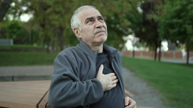 Senior Man In a Park Having Chest Pain Suffering Heart Attack
