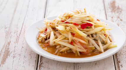 Som Tum Pla Ra, Thai E-San food, spicy papaya salad with pickled fish, tomato, lime and chilli in...
