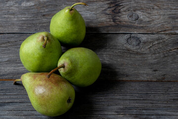 four pears on wooden table
