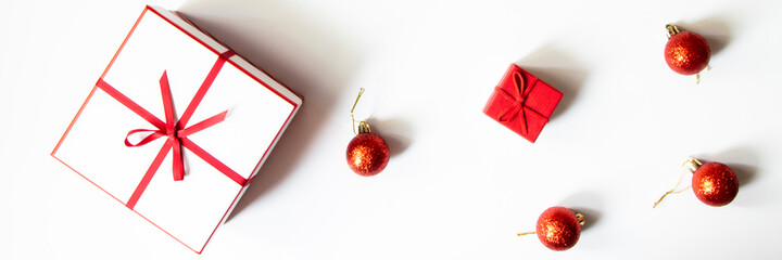 Christmas composition. Gifts, red decorations on a white background. Christmas, winter, new year concept. Flat lay, top view, copy space with space for text. Banner.