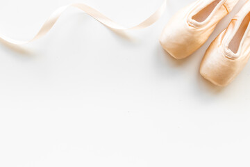 Pastel beige ballet pointe shoes or slippers with ribbon