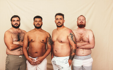 Fototapeta na wymiar Men standing together in a studio without shirts